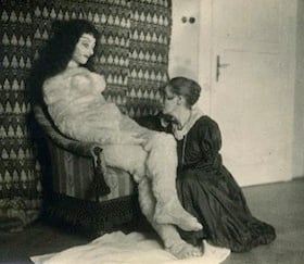 Hermine Moos posing with the Alma Mahler doll