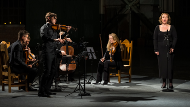 Image of violinist Benjamin Beilman, mezzo Sasha Cooke, and the St. Lawrence String Quartet in a performance dressed al in black