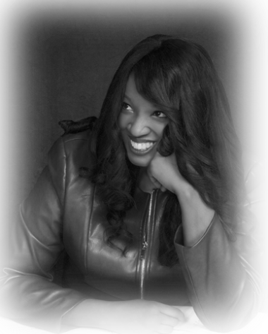A black and white image of Nkeiru Okoye, smiling with her chin resting on her hand.