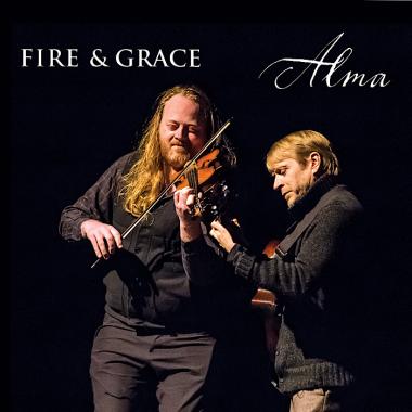 A tall man playing violin next to a shorter man playing guitar