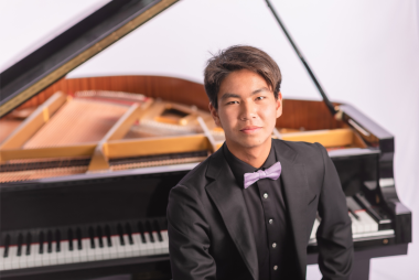 Soloist Stanford Yu sits at the piano