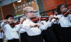 Young Colburn School students performing outside of the Colburn Cafe.