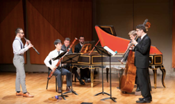 The Colburn School Baroque Ensemble members perform on stage.