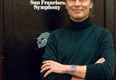 An image of Ragnar Bohlin standing in front of a black storage locker with the words "San Francisco Symphony" printed on it. 