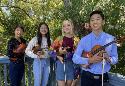 Photo of the Fourtés Violin Quartet (four youth holding their violins)