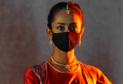 Woman in traditional Indian dress, wearing mask