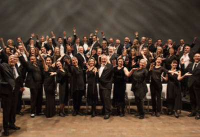 A photo of the San Francisco Opera Chorus dressed in all black attire.