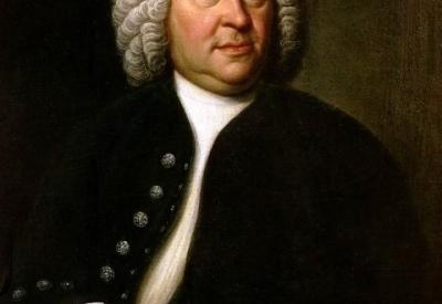 A portrait of Johann Sebastian Bach in a white shirt, black jacket, and white-haired wig holding sheet music.