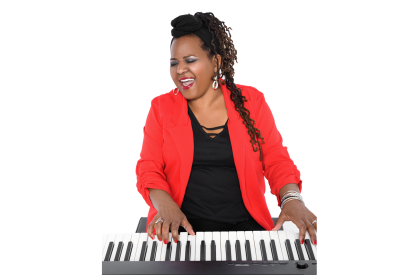 Musician Rita Lackey plays a piano keyboard while singing