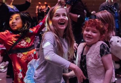 Kids dancing and having fun under the disco ball at the Dance-Along Nutcracker