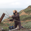 Cheryl Leonard bowing a steel cable at Marin Headlands
