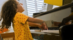 A child in Israel learning to play piano with the page-turning app 