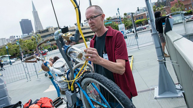 Tim Hawkinson with the bycicle component of his Exploratorium installation