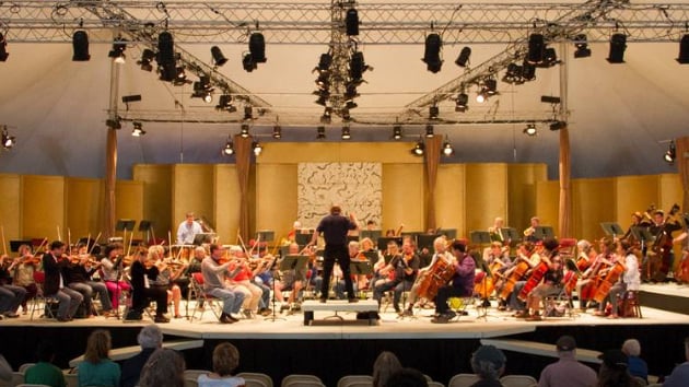 Allan Pllack conducts the orchestra inside the Tent Concert Hall of the Mendocino Music Festival. (Photo by Nicholas Wilson)